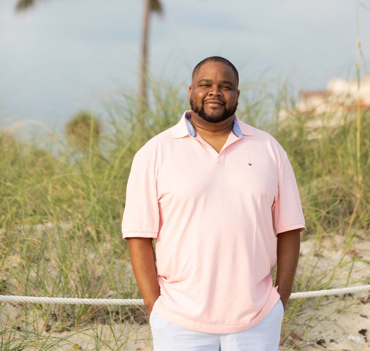 Darrell Reese with grass and palm tree in the background