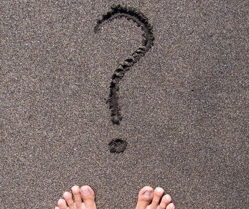 person standing on soft concrete with a question mark