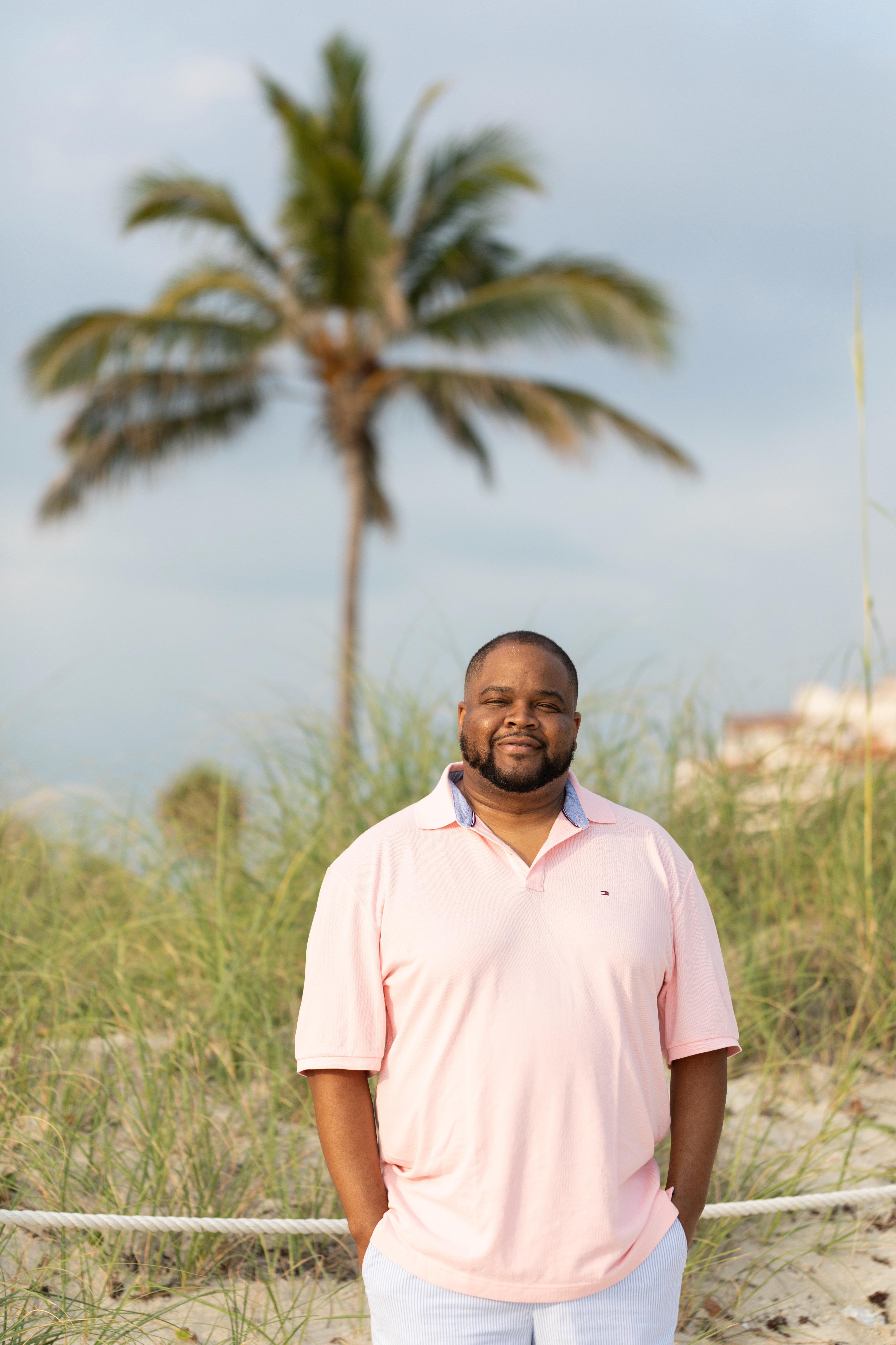 Darrell Reese with grass and palm tree in the background