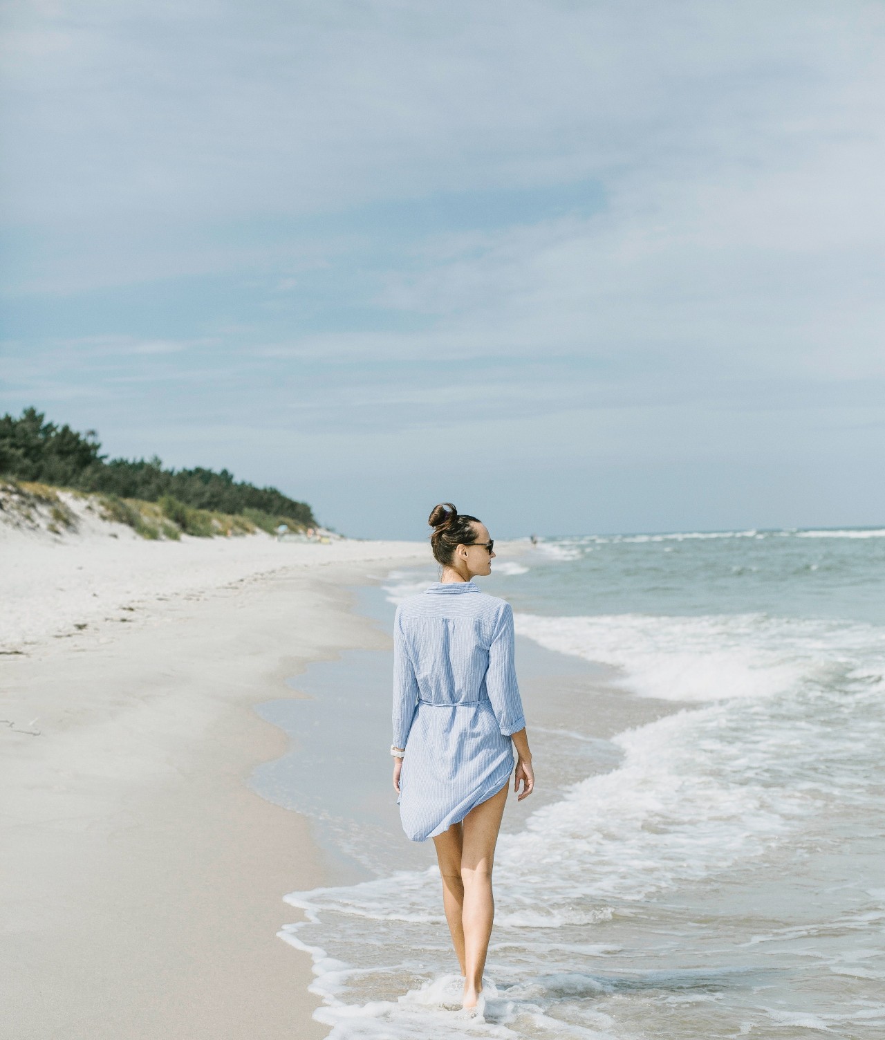 Woman walking in water on beach